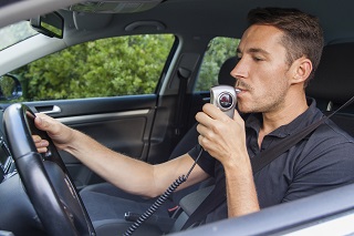 image of driver taking breathalizer