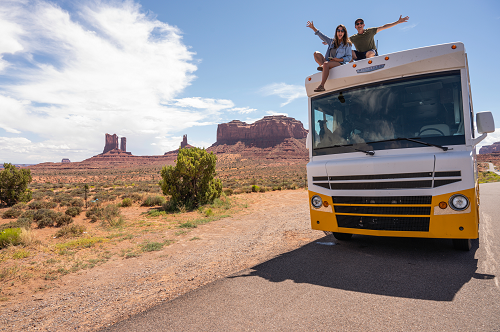 a bus traveling down a dirt road